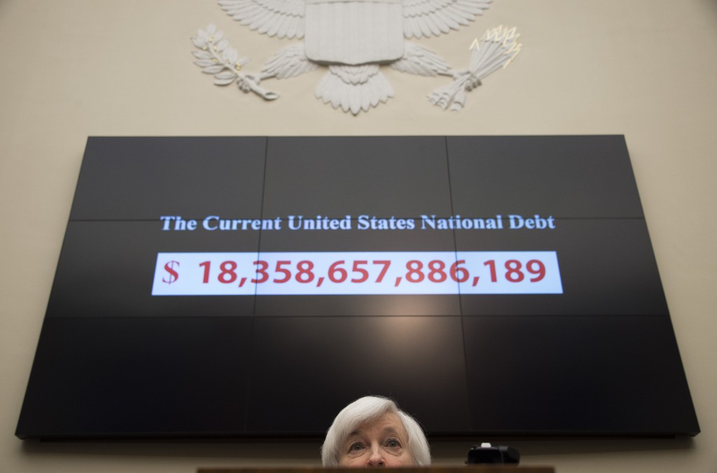 A graphic shows the rising current US national debt as Federal Reserve Chair Janet Yellen testifies before the House Financial Services Committee on Capitol Hill in Washington, DC, November 4, 2015 AFP PHOTO / JIM WATSON (Photo credit should read JIM WATSON/AFP/Getty Images)